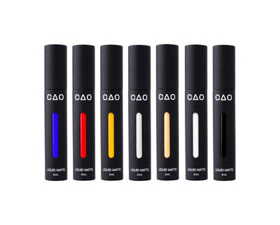 6 Black Matted tubes, vertical stretched oval windows, each filled filled with blue, red, yellow, silver metallic, gold metallic, white, and black liquid matte makeup.
