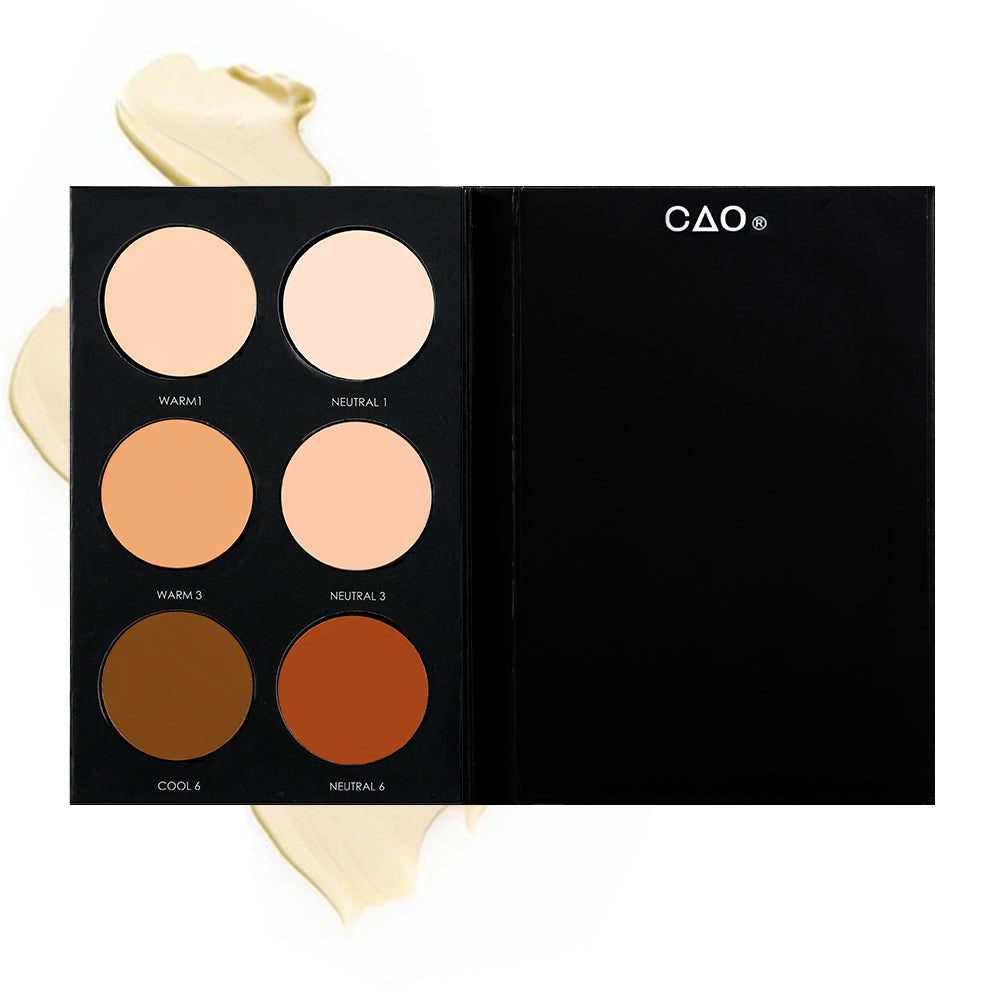 Black Matte rectangular cardboard palette with 6 circular openings for “Basic Foundation” refill cream product in shades Warm 1, Neutral 1, Warm 3, Neutral 6, Cool 6, and Neutral6 on top of creamy swatch.
