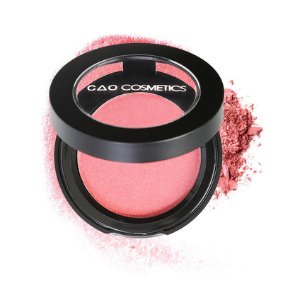 Round Matte Black Component, clear round top window, filled with compressed round powder blush shade in "Delicious" on top of loose powder swatch.