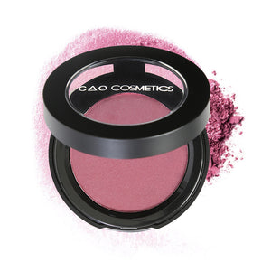 Round Matte Black Component, clear round top window, filled with compressed round powder blush shade in "Diva" on top of loose powder swatch.