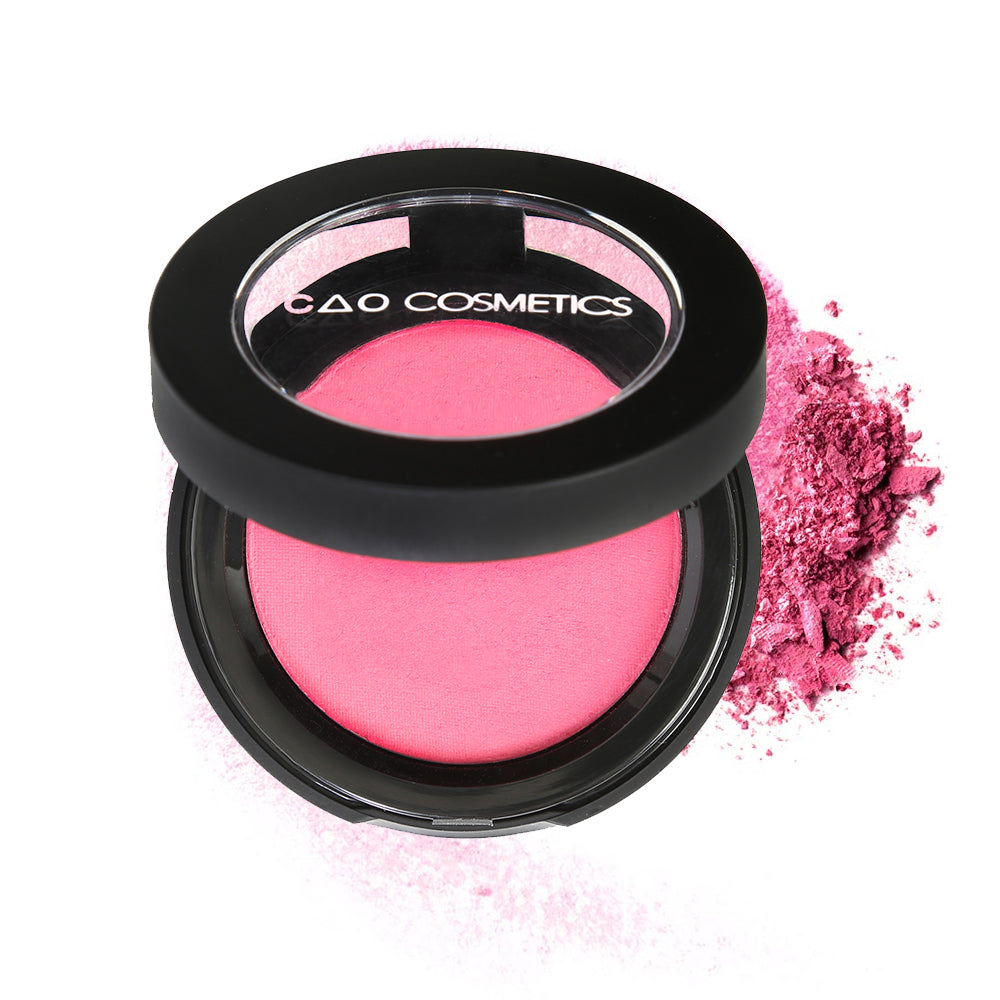 Round Matte Black Component, clear round top window, filled with compressed round powder blush shade in "Foxy" on top of loose powder swatch.
