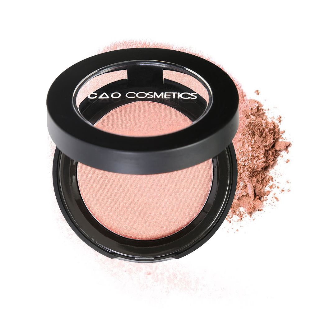 Round Matte Black Component, clear round top window, filled with compressed round powder blush shade in "Goddess" on top of loose powder swatch.