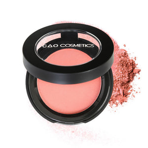Round Matte Black Component, clear round top window, filled with compressed round powder blush shade in "Just Peachy" on top of loose powder swatch.