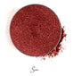 a dark red colored individual eyeshadow compressed powder refill in shade "sin"