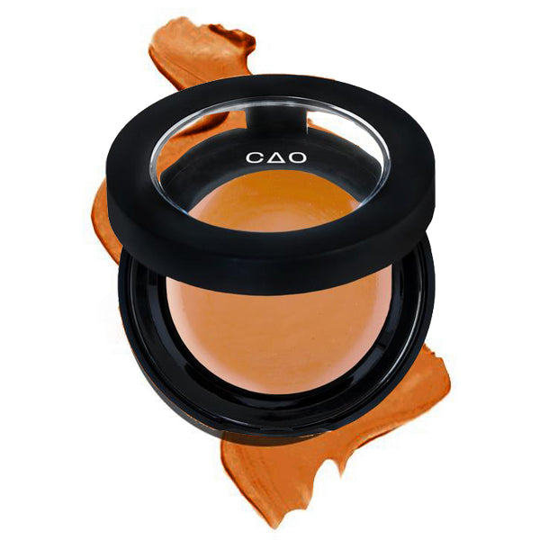 Round Matte Black Component, clear round top window, filled with round creamy concealer shade in "Dark" on top of creamy swatch.