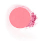 Round compressed  powder blush refill shade in "Delicious" on top of loose powder swatch.