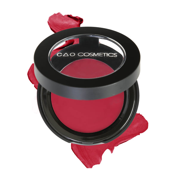 Round Matte Black Component, clear round top window, filled with round creamy dual lip and cheek product shade in "Desire" on top of creamy swatch.