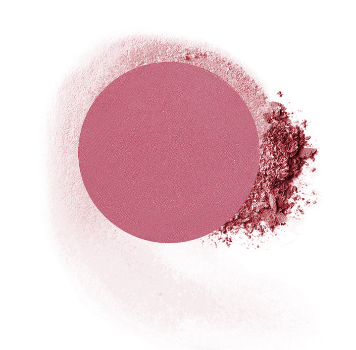 Round compressed  powder blush refill shade in "Diva" on top of loose powder swatch.