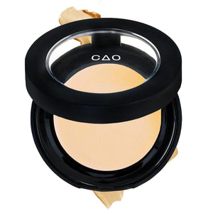 Round Matte Black Component, clear round top window, filled with round creamy concealer shade in "Lite" on top of creamy swatch.
