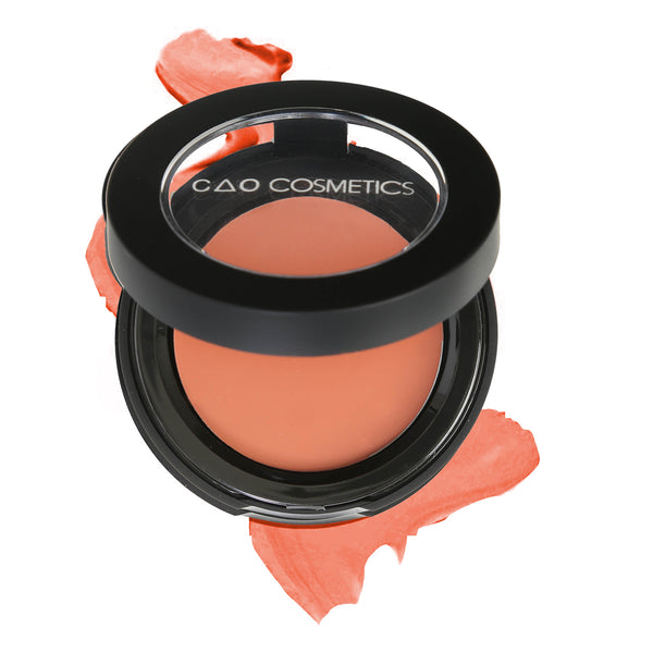 Round Matte Black Component, clear round top window, filled with round creamy dual lip and cheek product shade in "Naked" on top of creamy swatch.