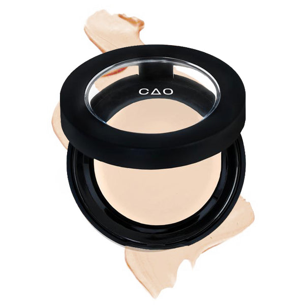 Round Matte Black Component, clear round top window, filled with round creamy concealer shade in "Ultra Lite" on top of creamy swatch.